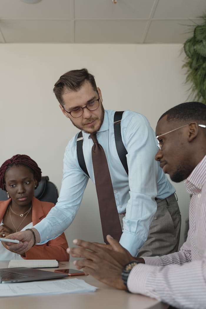 A group of professionals engaged in a collaborative meeting in a modern office setting.